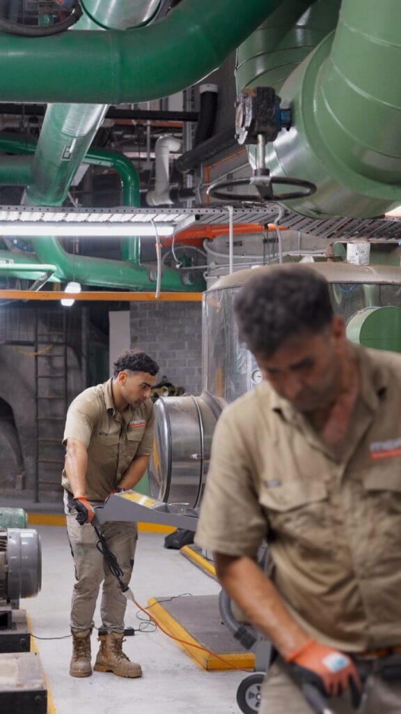 MEFS crew preparing the concrete floor in a commercial plant room